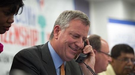Mayor Bill de Blasio takes a phone call