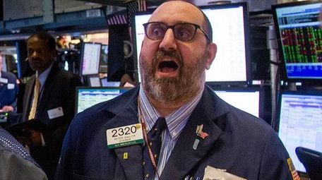 Traders work on the floor of the