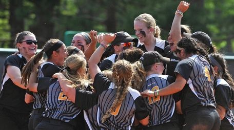 Adelphi softball teammates celebrate after their 4-1 win