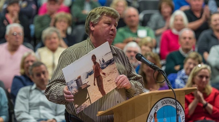 David Raynor, 56, shows a photo of himself