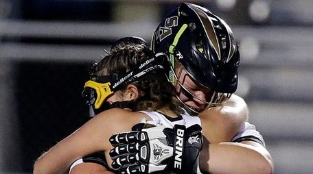 St. Anthony's goalie Charoltte Campbell (29) tearfully embraces