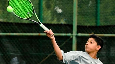 Syosset's Neel Rajesh hits a forehand during Nassau's