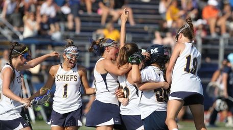 Massapequa celebrates the win during the Nassau School