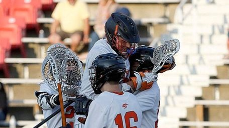 Babylon lacrosse players celebrate their victory over Mattituck/Greenport/Southold