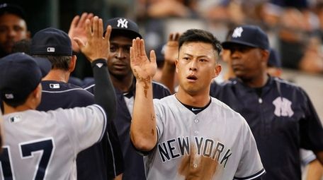 New York Yankees' Rob Refsnyder celebrates scoring on