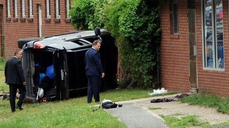 Suffolk County investigators look over the scene of