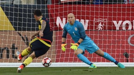 Colombia's James Rodriguez scores a penalty past USA's