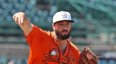 Ducks pitcher Mark Blackmar throws to first in