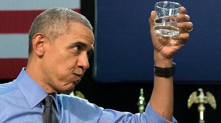 President Barack Obama holds up a glass of