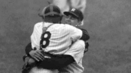 New York Yankees catcher Yogi Berra leaps into