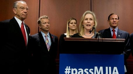 Sen. Kirsten Gillibrand, front, with, from left, Sen.