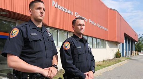 Nassau County Police Officers Ronald Curaba, left, and