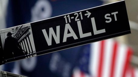 A Wall Street sign adjacent to the New