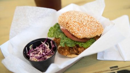 A very fresh fried fish sandwich wears lettuce,