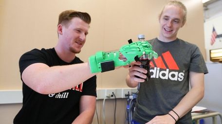 Senior Kyle Wappaus, 17, left, demonstrates use of