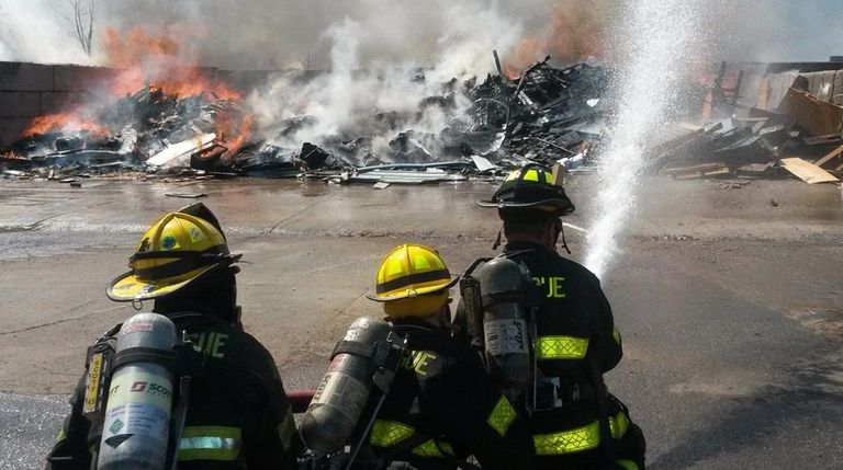 A pile of construction debris two-stories high burned