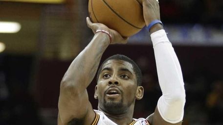 Cleveland Cavaliers' Kyrie Irving shoots a 3-point shot