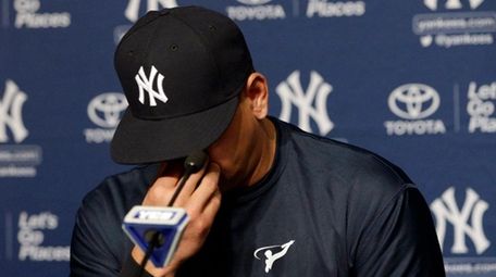 Alex Rodriguez reacts as he addresses the media
