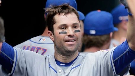 New York Mets' Neil Walker is congratulated in