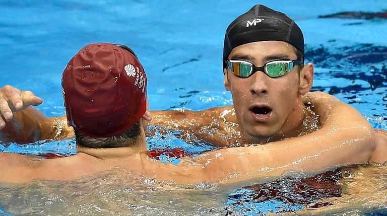 Michael Phelps from the United States is congratulated