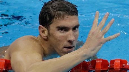 United States' Michael Phelps celebrates winning gold in