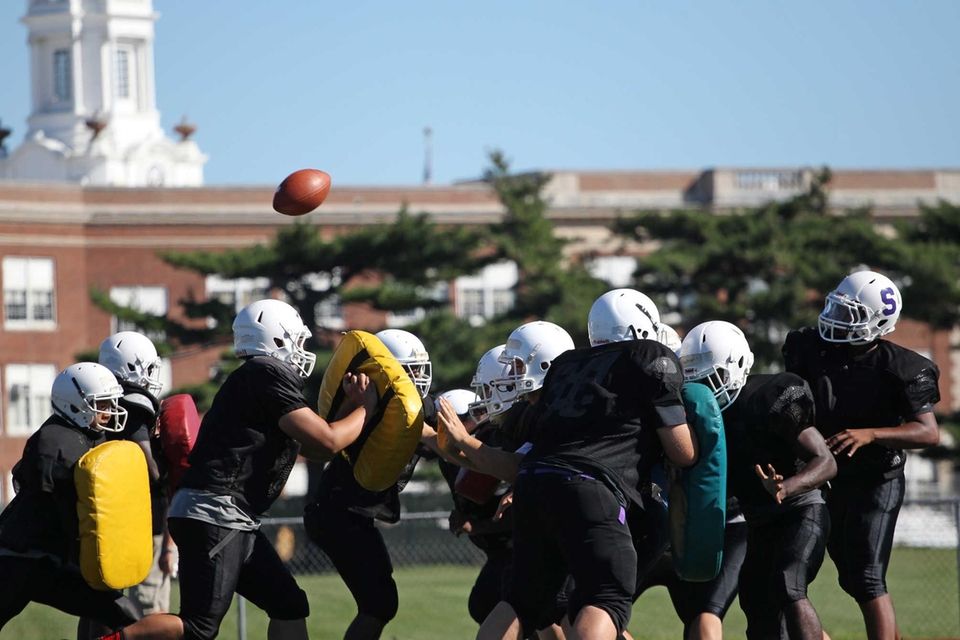 Players do a blocking drill during practice at