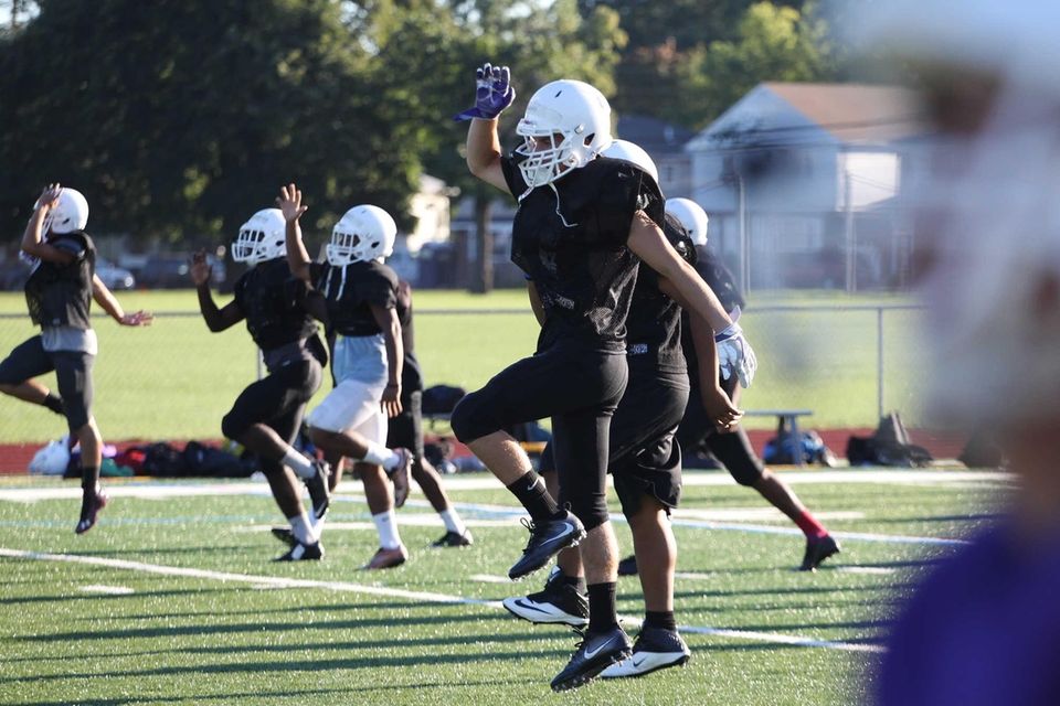 Players warm up during practice at Sewanhaka High