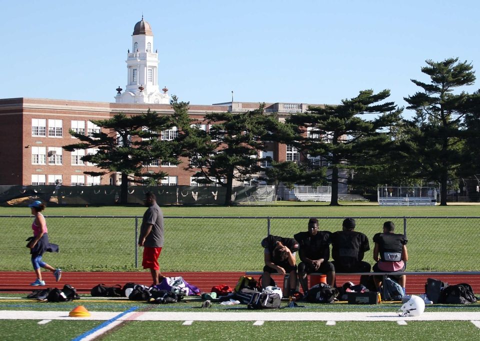 Players take a break during practice at Sewanhaka