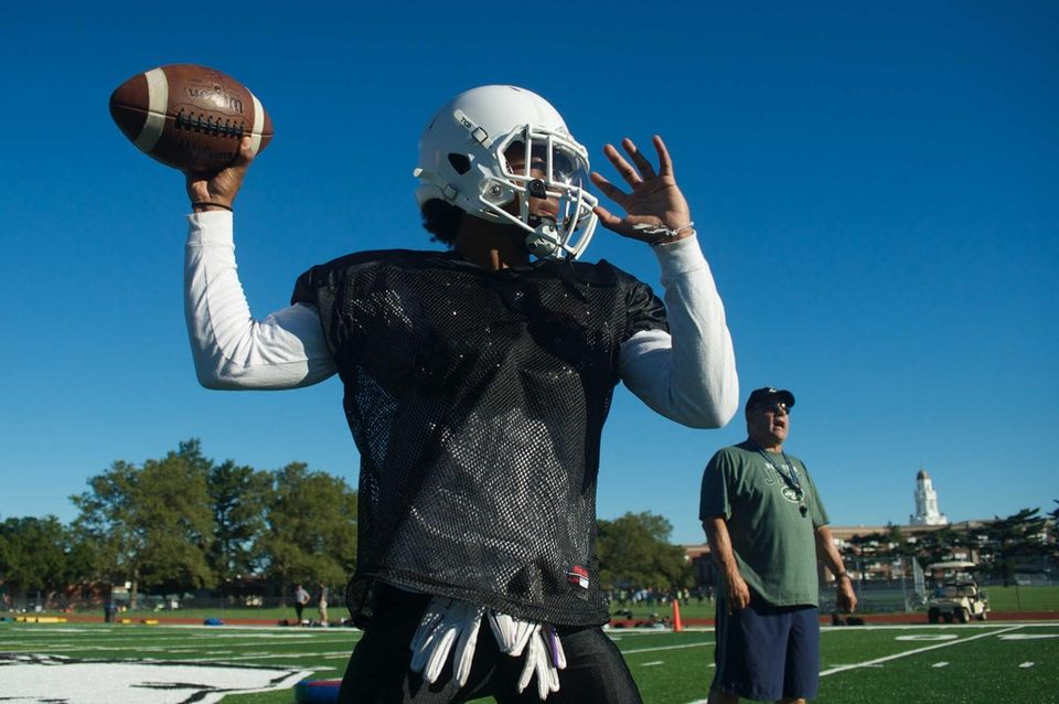 A player throws a pass during practice at