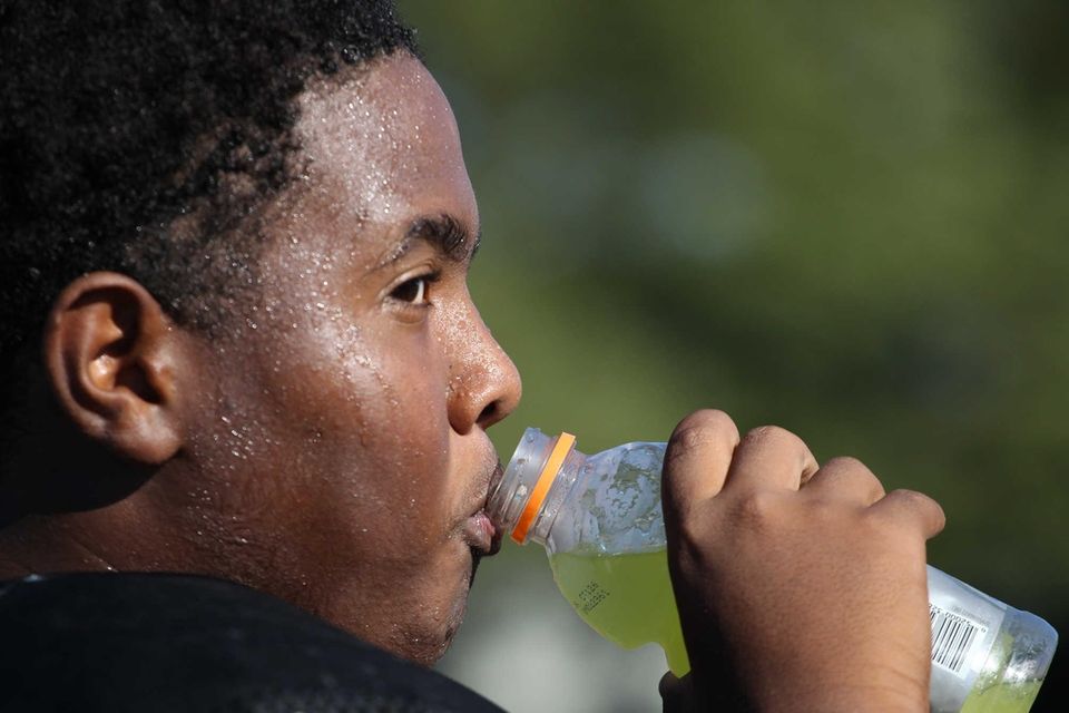 Joshua Turbi drinks during a water break at