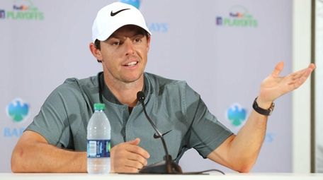 Rory McIlroy of Northern Ireland speaks to the