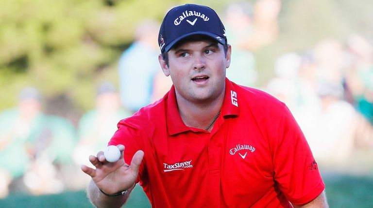 Patrick Reed waves to the gallery on the