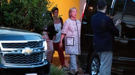 Democratic presidential candidate Hillary Clinton, center, leaves a