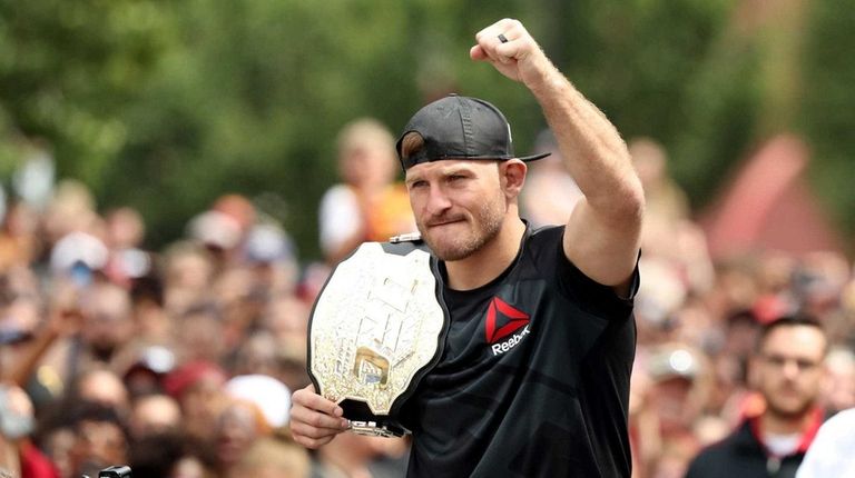 UFC heavyweight champion Stipe Miocic looks on during