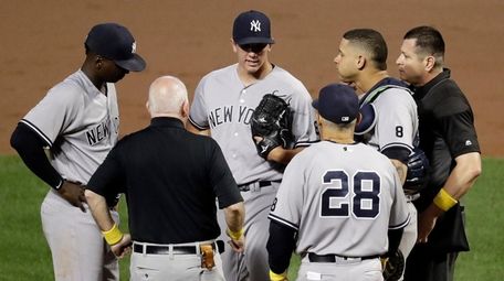 New York Yankees starting pitcher Chad Green, center,