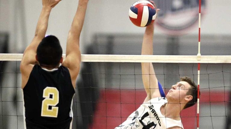 Eastport's Tommy Ogeka, right, spikes the ball against