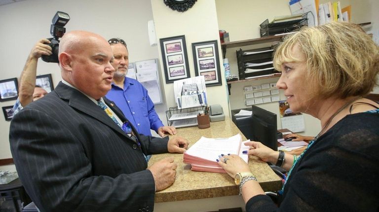 Bob Miller, left, turns over stacks of signatures