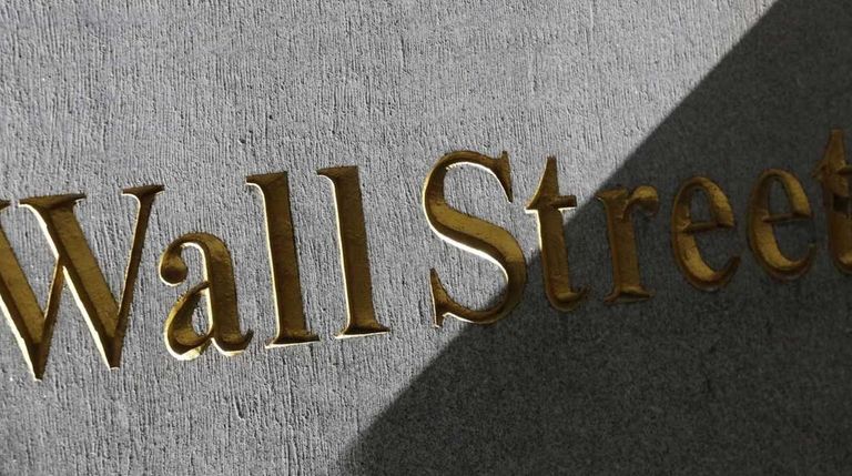 A Wall Street sign is seen on the