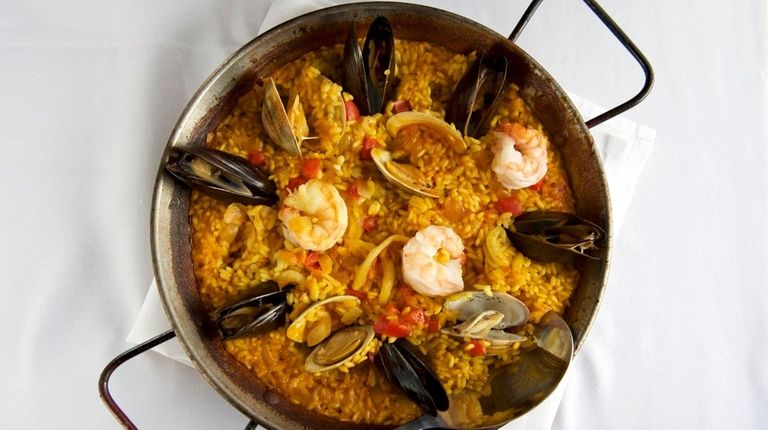 Seafood paella includes mussels, clams, shrimp, lobster and