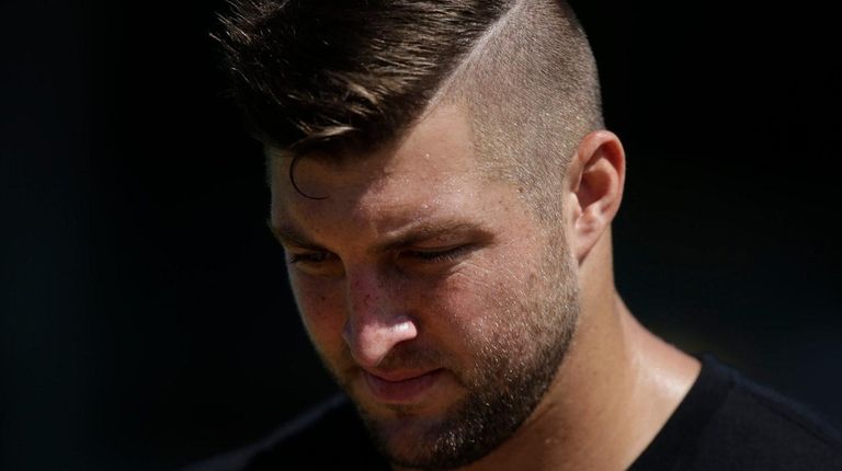 Former NFL quarterback Tim Tebow arrives at USC's