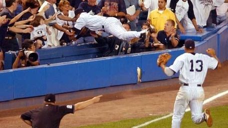 Derek Jeter leaps into the stands late in
