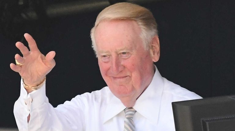 Los Angeles Dodgers broadcaster Vin Scully acknowledges the