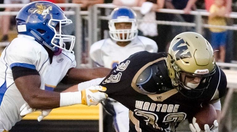 Wantagh's Jimmy Joyce scores as Roosevelt's Corey Bull