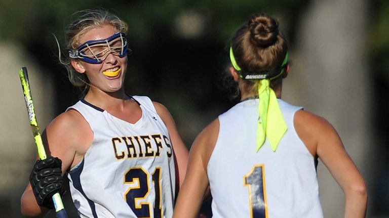 Mackenzie Conkling of Massapequa, right, gets congratulated by