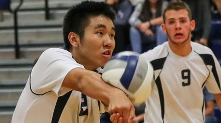 Daniel Kim of Plainview JFK, returns Massapequa's serve
