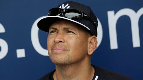 Alex Rodriguez sits in the Yankees' dugout during