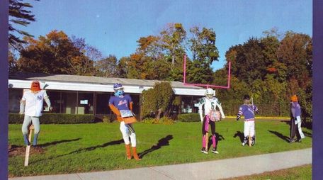 St. James Elementary School students make scarecrows during