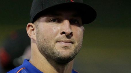Former NFL quarterback Tim Tebow gets ready for