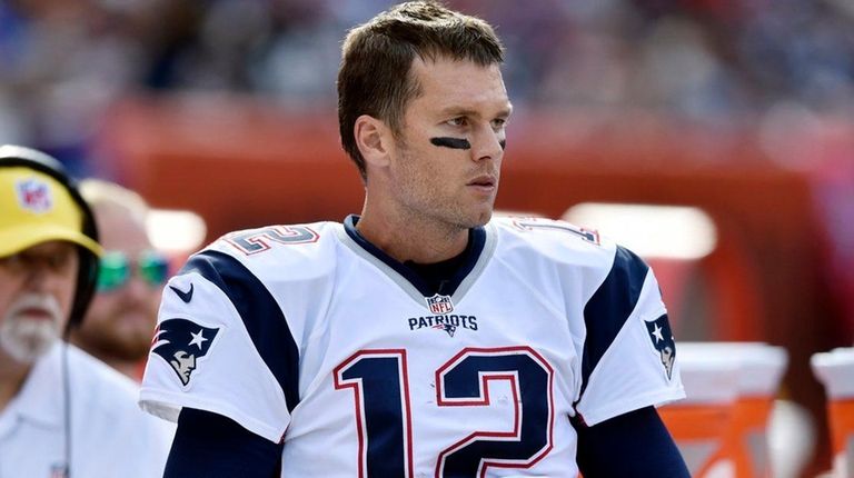 New England Patriots quarterback Tom Brady watches from
