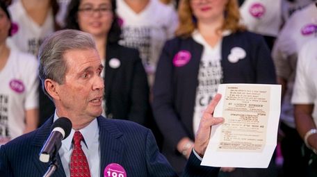 Alexander Sanger holds up a copy of a